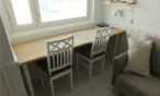 Dining table and chairs by the window in 21 m² Levi apartment