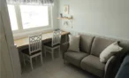 Sofa and table by the window in 21 m² Levi apartment