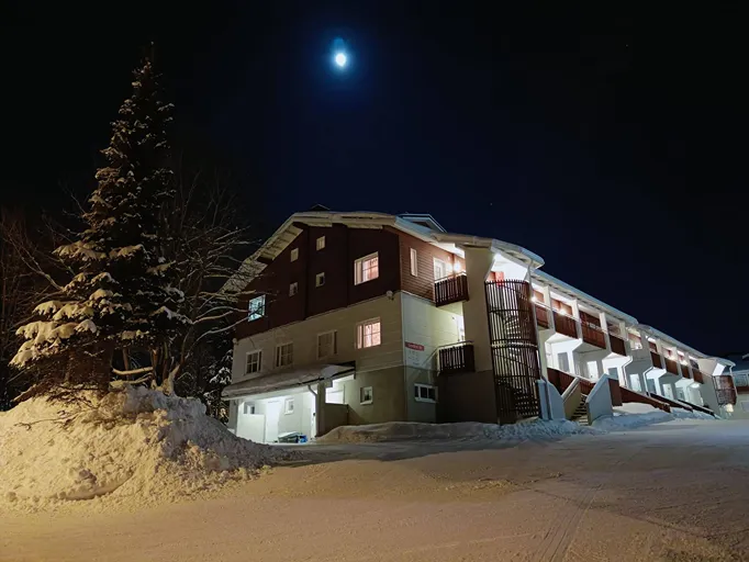 The Levistar III apartment building in Levi at night under a clear sky