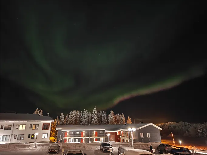 Northern lights over the apartment area in Levi