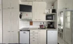 Kitchenette with induction hob, dishwasher, fridge, microwave and coffee maker in the 21 m² B apartment, Levi