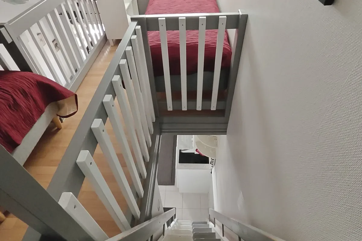 View down the steep loft stairs from the loft in the 27 m² A apartment