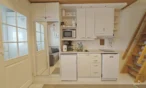 Kitchenette and loft stairs in Leviloma 27 m² B apartment, Levi