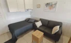 Bed and sofa in Leviloma 27 m² C apartment, Levi